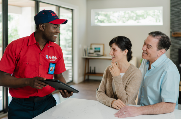 Mr. Rooter professional going over plumbing costs with customers.