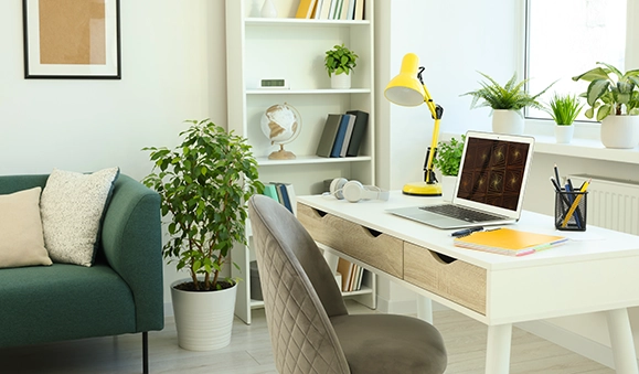 Home office with desk and large windows