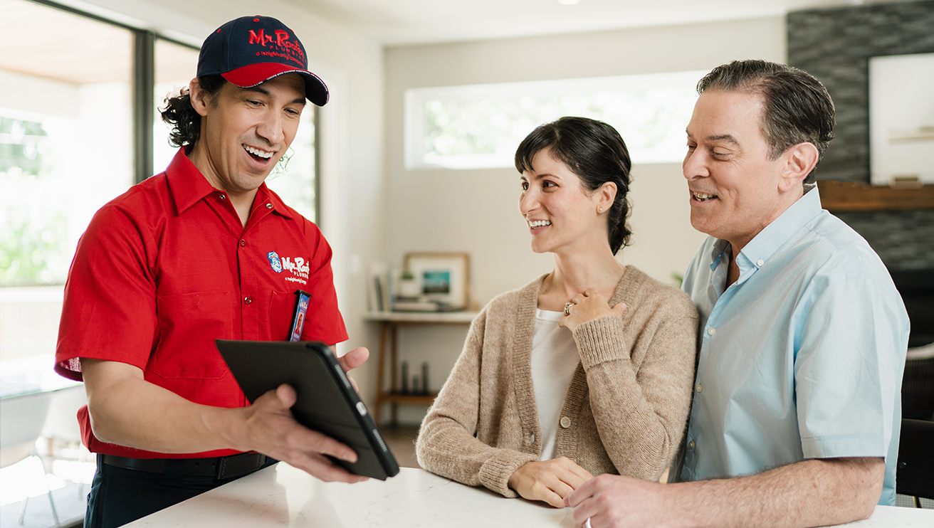 Mr. Rooter technician helping customers choose services.