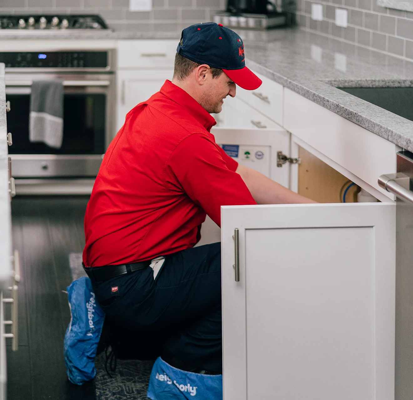 Mr. Rooter technician fixing a hot water dispenser.