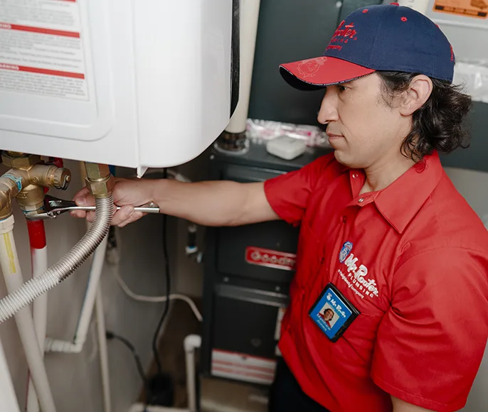 Mr. Rooter technician working on a tankless water heater.