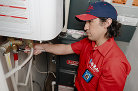 Mr. Rooter professional working on a water heater.