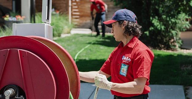 Mr. Rooter professional preparing to clean a sewer.