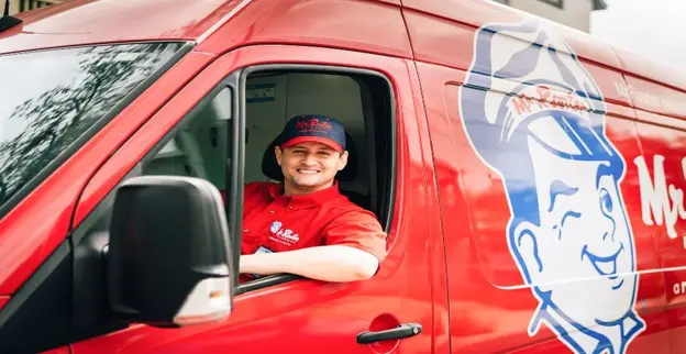 Mr. Rooter plumber in van.