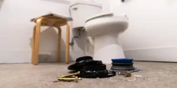 Toilet flange on a bathroom floor.