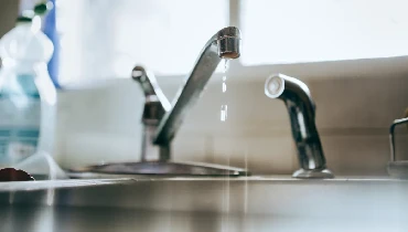 A dripping kitchen sink faucet.