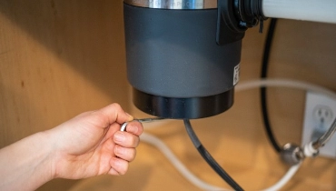 A garbage disposal under a sink.