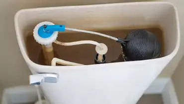 The inside of a toilet tank, with the lid off.